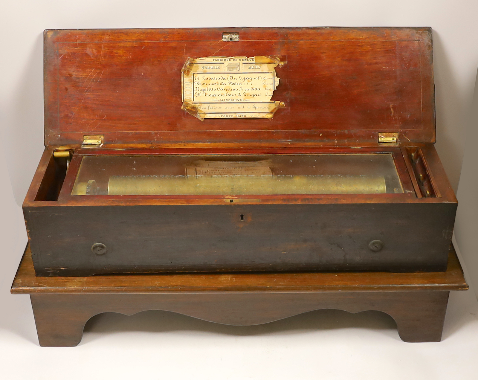 A late 19th century Swiss ‘forte piano’ cylinder musical box, in an inlaid mahogany case, playing four airs on two hundred and nineteen teeth, barrel 39cm wide, case; 57cm wide, 17cm deep, 13cm high, on a later separate